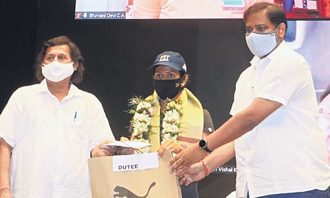 Sports Minister Tusharkanti Behera and KISS founder Achyuta Samanta felicitating Dutee Chand in Bhubaneswar on Sunday (Photo | Express)