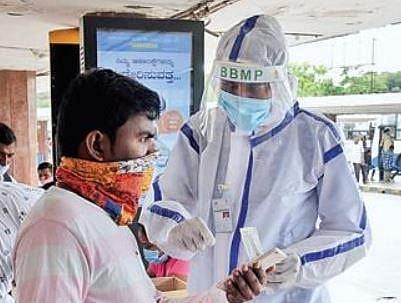 A health worker collects swab samples at the BMTC Terminal  in Bengaluru on Monday | Vinod Kumar T