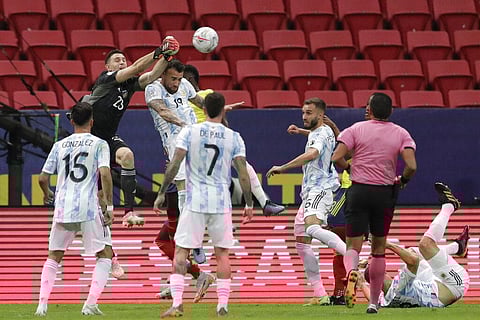 Argentina's goalkeeper Emiliano Martinez, left above, stops a ball during a Copa America semifinal soccer match against Colombia. (Photo | AP)