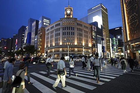 People walk along a pedestrian crossing at Ginza shopping district Wednesday, July 7, 2021, in Tokyo. (Photo | AP)