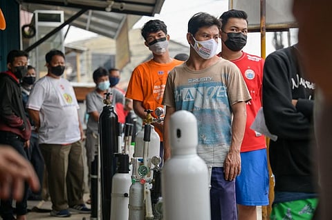 Indonesians queue at an oxygen filing shop to fill tanks for sick family members in Jakarta on June 30, 2021, as Covid-19 infections soar to record highs in Indonesia. (File Photo | AFP)