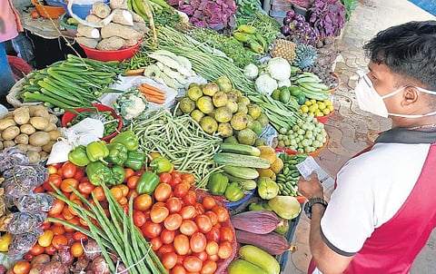 A customer buys vegetable from a shop at Palayam Connemara Market in Thiruvananthapuram. | B P Deepu