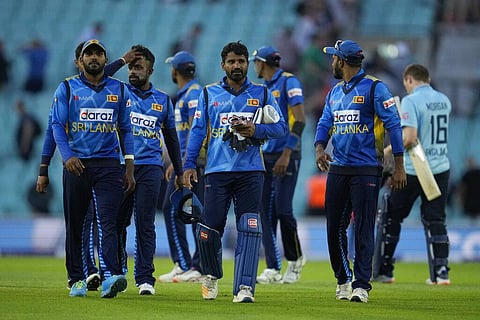 Sri Lanka's captain Kusal Perera, centre, walks off the field with his teammates. (Photo | AP)