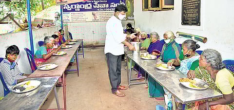 A staffer serving food to inmates of the old-age home started by Swarnandhra in Rajamahendravaram | Express
