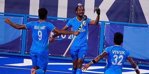 India's Hardik Singh (8) celebrates with his teammates after scoring against Great Britain. (Photo | AP)