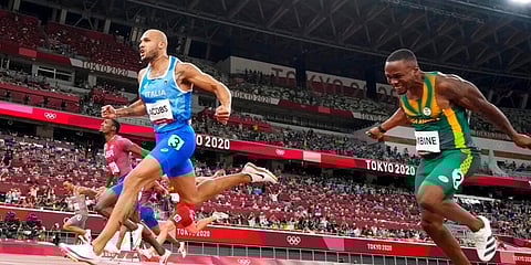 Lamont Jacobs (C) of Italy celebrates after winning the men's the 100-meter final at the 2020 Summer Olympics. (Photo | AP)