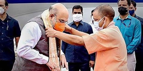 Uttar Pradesh Chief Minister Yogi Adityanath welcomes Home Minister Amit Shah on his arrival in Lucknow. (Photo | PTI)