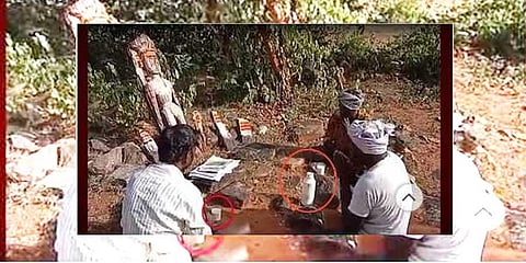 A screen grab of the three Chenchu men placing land-related documents in front of the deity and praying for the  protection of  their village