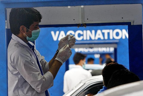 A health worker prepare the Sinovac COVID-19 vaccine at a drive-through vaccination center, in Karachi, Pakistan, Saturday, July 31, 2021. (Photo | AP)