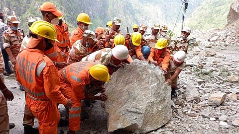 Members of the National Disaster Response Force (NDRF) working on a rescue operation at the site of a landslide in Kinnaur district in Himachal. 