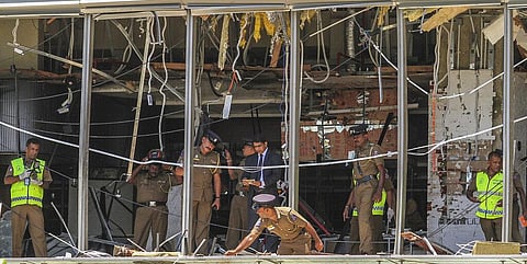 Sri Lankan police officers inspect the site of an explosion at the Shangri-la hotel in Colombo. (Photo | AP)