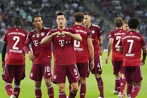 Bayern's Robert Lewandowski, center, celebrates after scoring first goal during Bundesliga match against Borussia Moenchengladbach on Friday, Aug. 13, 2021. (Photo | AP)