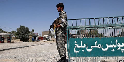 An Afghan policeman stands guard on the outskirts of Mazar-e-Sharif in Afghanistan. (File photo| AP)