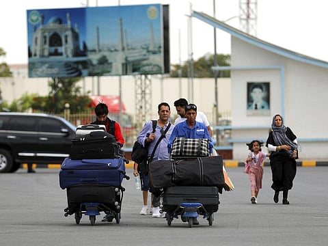 Passengers walk to the departures terminal of Hamid Karzai International Airport in Kabul, Afghanistan, Saturday, Aug. 14, 2021. (Photo | AP)