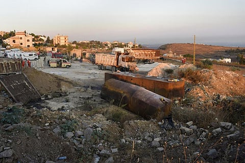 Rescue workers and Lebanese soldiers gather at the scene where a fuel tanker exploded, in Tleil village, north Lebanon. (Photo | AP)
