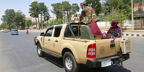 Taliban fighters sit on the back of a vehicle in the city of Herat, west of Kabul. (Photo | AP)