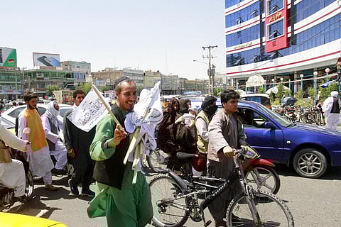 A man sells Taliban flags in Herat province, west of Kabul, Afghanistan, on Saturday, Aug. 14, 2021. (Photo | AP)