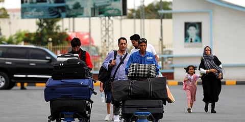 Passengers walk to the departures terminal of Hamid Karzai International Airport in Kabul, Afghanistan. (Photo | AP)