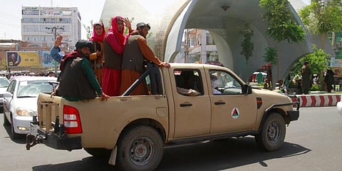 Taliban fighters pose on the back of a vehicle in Afghanistan. (Photo | AP)