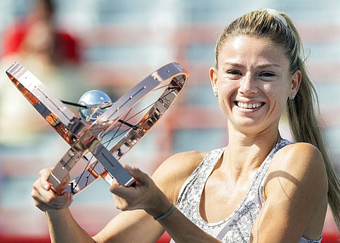 Camila Giorgi, of Italy, holds up her trophy following her victory over Karolina Pliskova at the final of the National Bank Open women's tennis tournament final in Montreal. (Photo | AP)