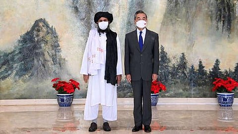 In this photo released by Xinhua News Agency, Taliban co-founder Mullah Abdul Ghani Baradar and Chinese Foreign Minister Wang Yi pose during their meeting in Tianjin, China last month. (Photo | AP)