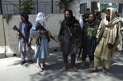 Taliban fighters stand guard at the main gate leading to the Afghan presidential palace, in Kabul, Afghanistan. (Photo | AP)