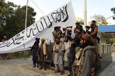 Taliban fighters raise their flag at the Ghazni provincial governor's house. (Photo | AP)