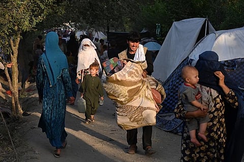 Internally displaced Afghan families, who fled from Kunduz, Takhar and Baghlan province, walk in front of their temporary tents at Sara-e-Shamali in Kabul on August 11, 2021. (Photo | EPS)