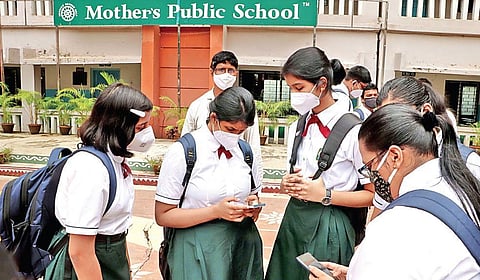 Students checking results on their mobile phones in Bhubaneswar. (Photo I EPS/Irfana)