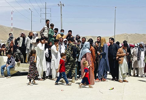 Hundreds of people gather outside the international airport in Kabul, Afghanistan. (Photo | AP)