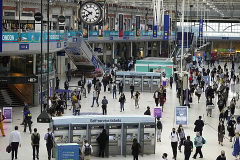 People wear face masks to curb the spread of coronavirus during the morning rush hour at the commuter hub, Waterloo train station in London. (File Photo | AP)
