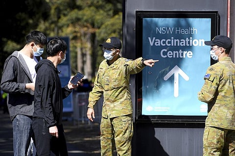 Australian Defense Force personnel assist the public at a COVID-19 vaccination clinic in Sydney. (Photo | AP)