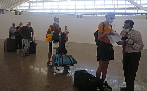An Australian woman is checked by a security during his departure at Ngurah Rai International airport, Bali. (Photo | AP)