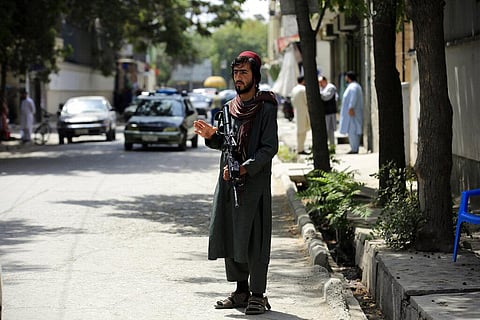 A Taliban fighter stands guard at a checkpoint in Wazir Akbar Khan in the city of Kabul, Afghanistan. (Photo | AP)
