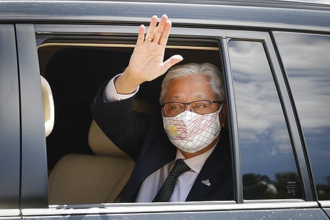 Former Deputy Prime Minister Ismail Sabri Yaakob waves to media as he leave after meeting with the King at national palace in Kuala Lumpur. (Photo | AP)