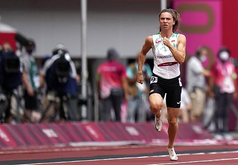 Krystsina Tsimanouskaya, of Belarus, runs in the women's 100-meter run at the 2020 Summer Olympics, Friday, July 30, 2021. (Photo | AP)