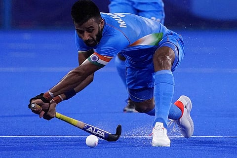 India's Manpreet Singh (7) passes against Japan during a men's field hockey match at the 2020 Summer Olympics. (Photo | AP)