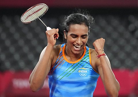 India's Pusarla V. Sindhu celebrates after winning against He Bing Jiao of China during their women's singles badminton bronze medal match. (Photo | AP)