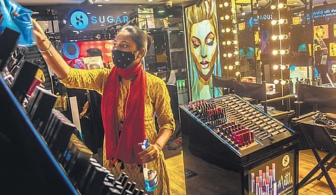 A worker sanitises products in a store at Utkal Kanika Galleria mall in Bhubaneswar. (Photo| EPS)