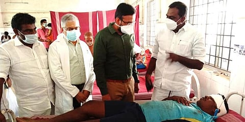 Nagapattinam District Collector A Arun Thamburaj visiting the injured fisher E Kalaiselvan. (Photo | EPS)