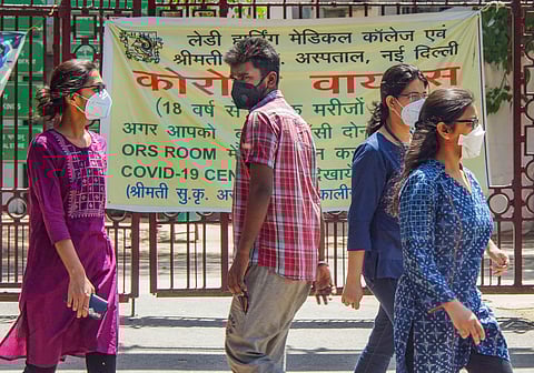 Lady doctors and a man wearing face masks walk outside the Lady Hardinge Medical College during ongoing COVID-19 lockdown in New Delhi. (File Photo | PTI)