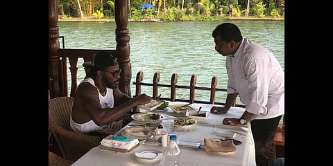 Cricketer Chris Gayle sampling some of Suresh Pillai’s delicacies.
