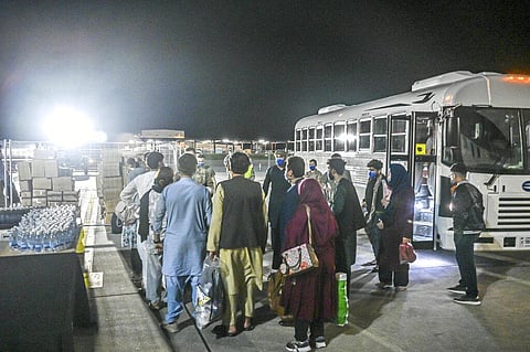 In this image provided by the U.S. Air Force, a group of Afghan evacuees depart a bus at Ramstein Air Base, Germany, Friday, Aug. 20, 2021. (Photo | AP)