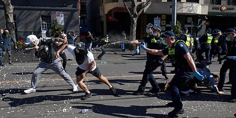 Police use pepper spray on protesters during an anti-lockdown protest in Melbourne. (Photo | AP)