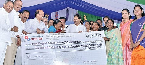 YS Jagan Mohan Reddy hands over the cheque to AgriGold depositors at Police Parade Grounds in Guntur on Thursday. (File Photo | EPS)