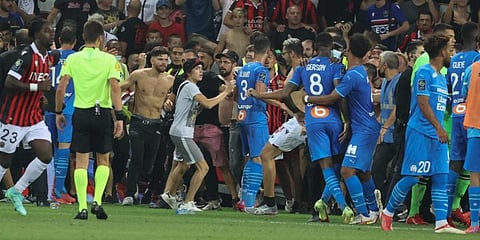 Fans invade the pitch during the French L1 football match between OGC Nice and Olympique de Marseille (OM) at the Allianz Riviera stadium in Nice, southern France. (Photo | AFP)