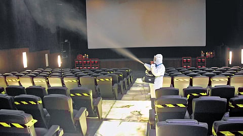A day ahead of reopening, a theatre in Chennai being sanitised on Sunday. (Photo | EPS/Ashwin Prasath)