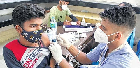 A health worker administers a dose of Sputnik V coronavirus vaccine to a beneficiary at a vaccination centre, in Gurugram (File Photo | PTI)