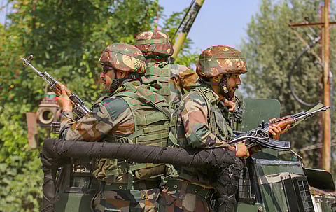Security personnel during an encounter with militants at Sopore area of Baramulla district, Tuesday. (Photo | PTI)