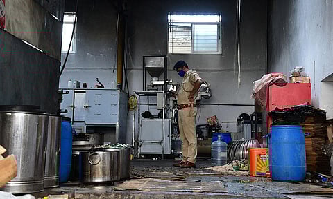 A police officer at the unit where a boiler burst in Bengaluru on Monday | Shriram BN